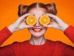 Girl with orange slices over eyes vitamin c immune support