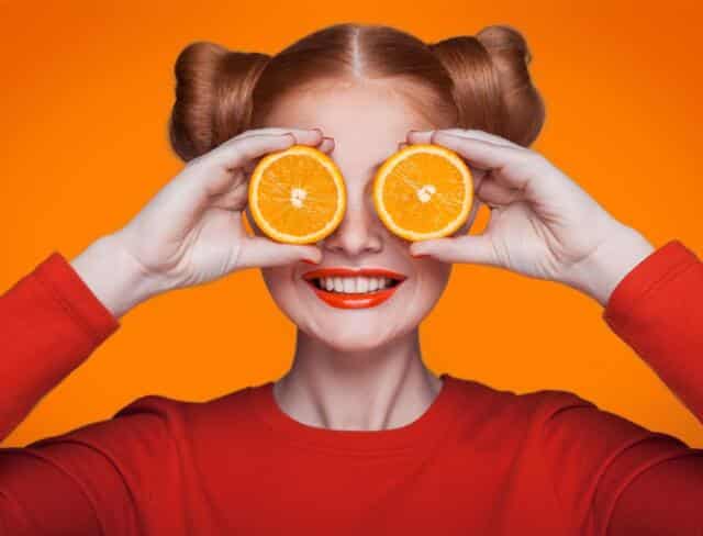 Girl with orange slices over eyes vitamin c immune support